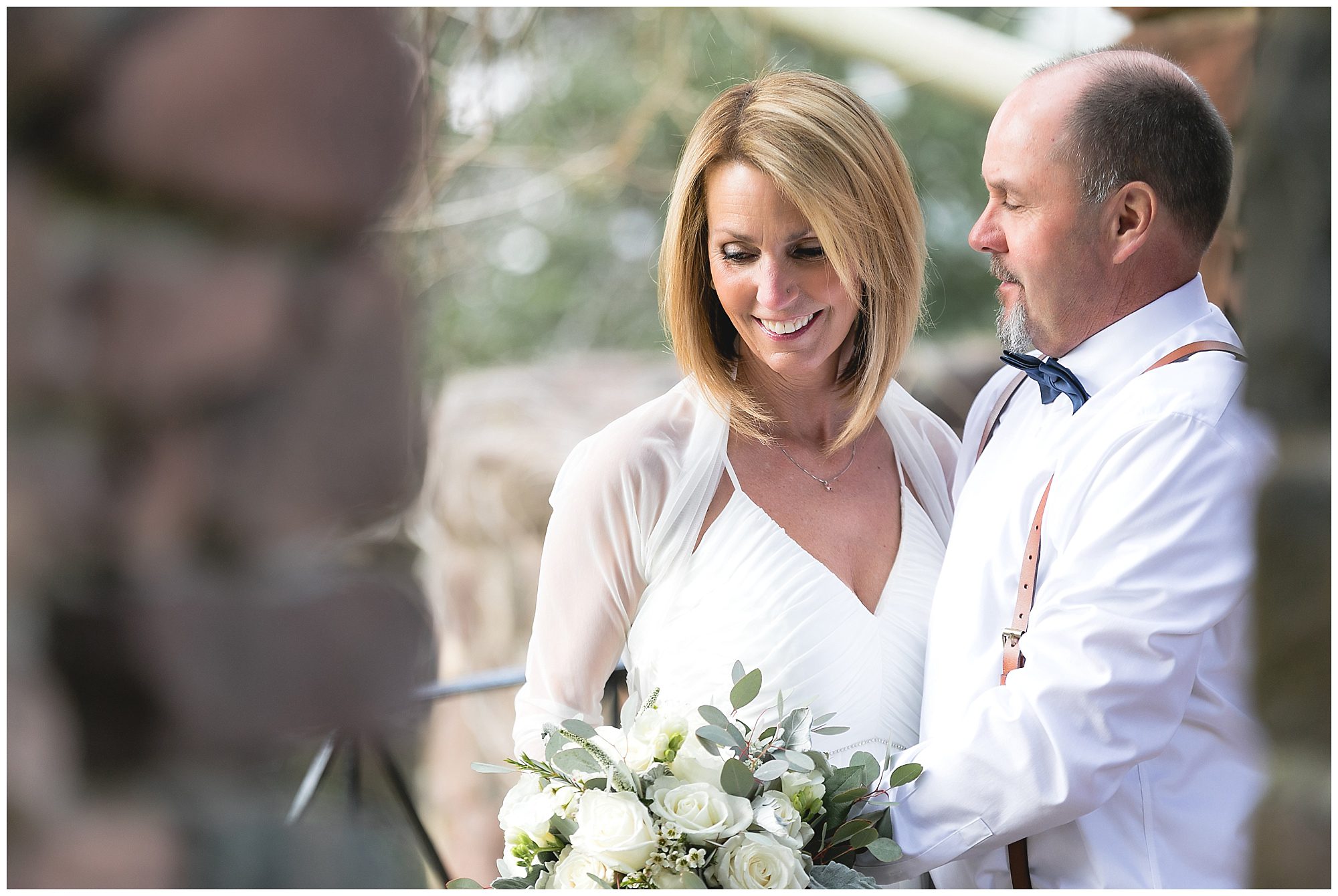 couple looking down at flowers