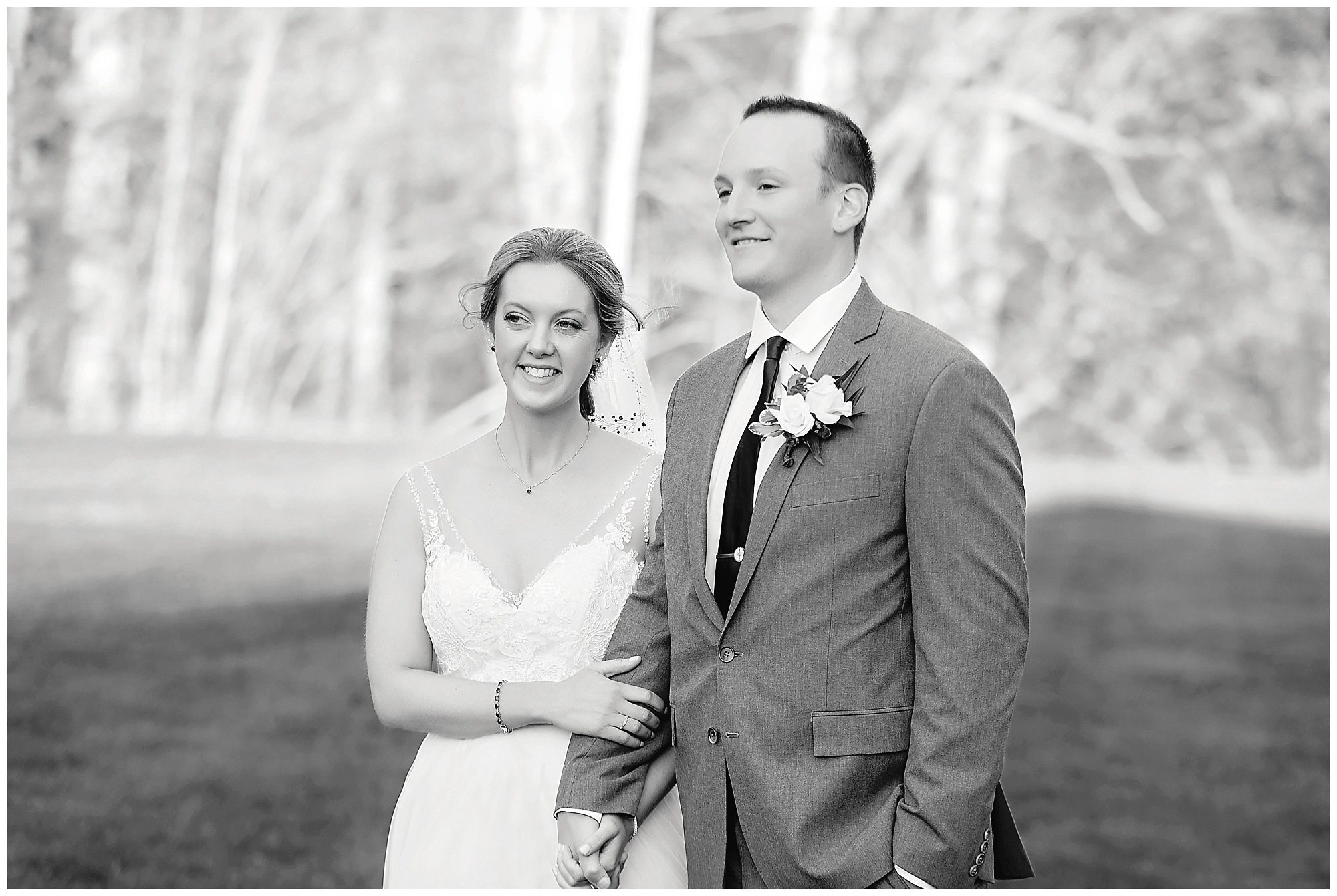 black and white image of couple posing for wedding pictures