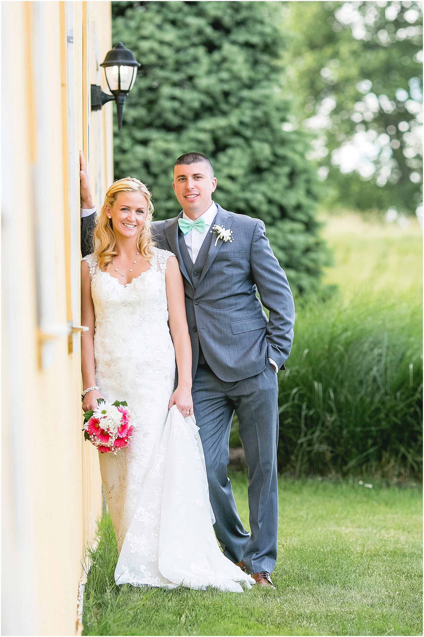 bride and groom by a barn the ranch