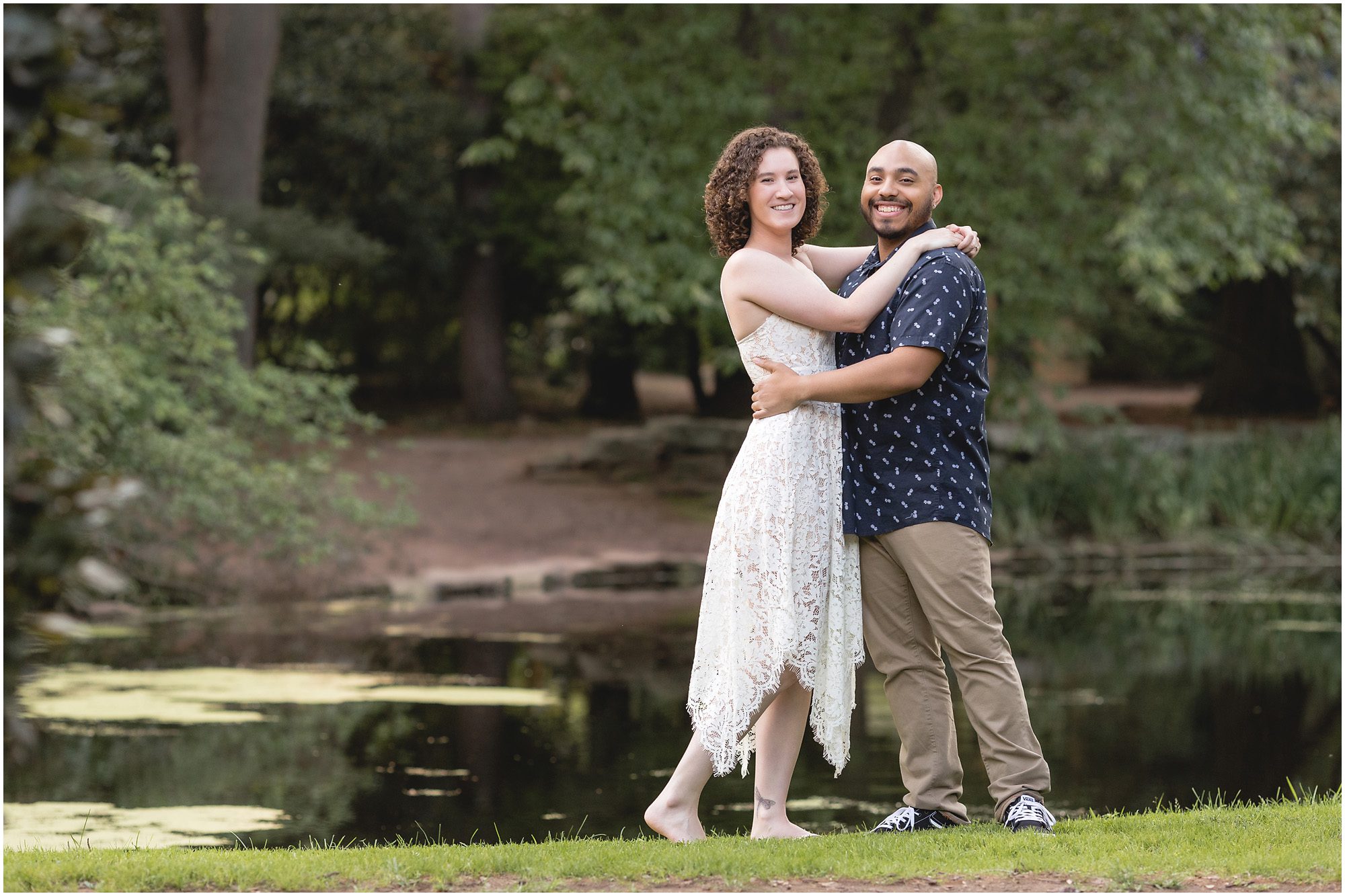 man and woman in front of pond