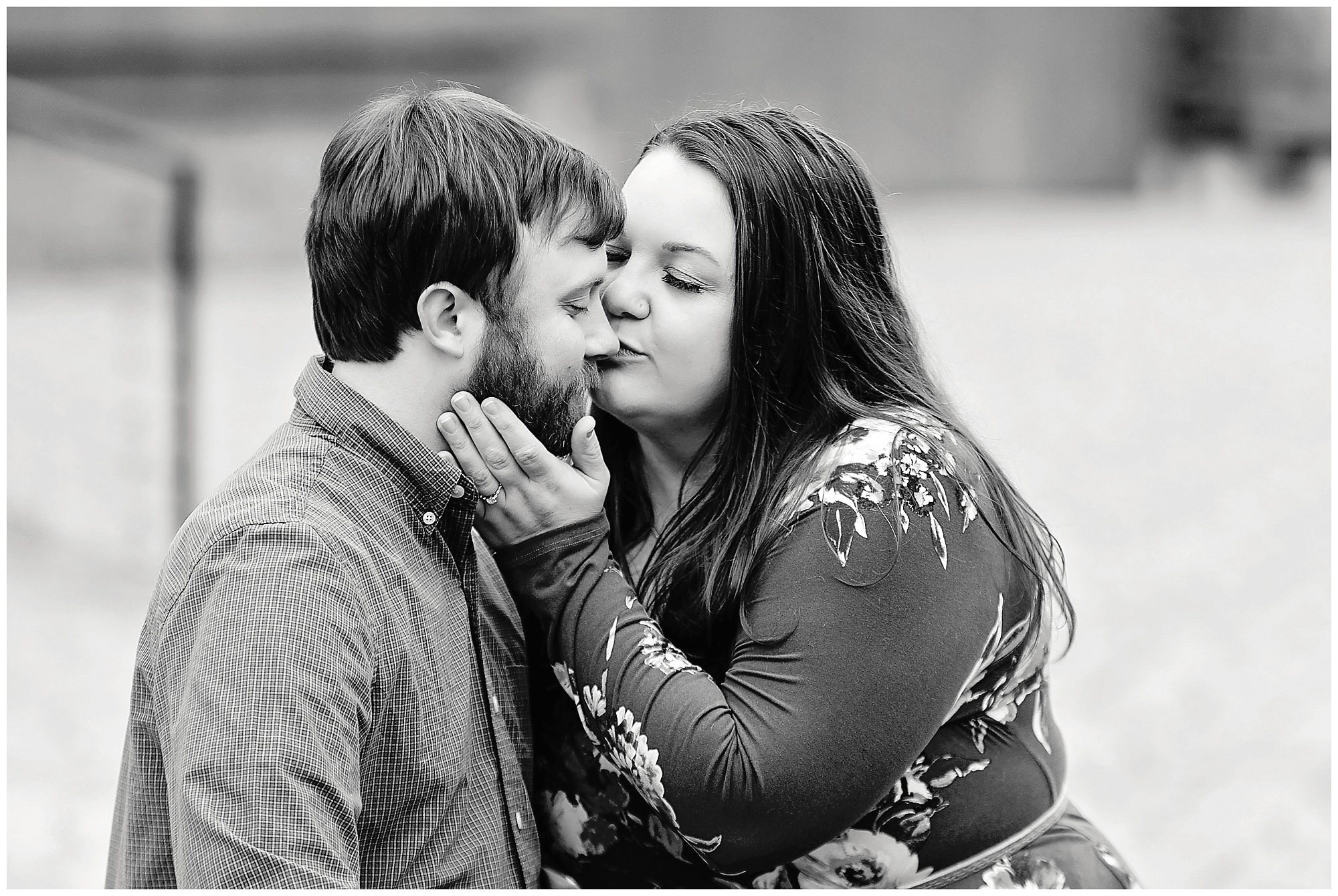 engaged couple kissing black and white