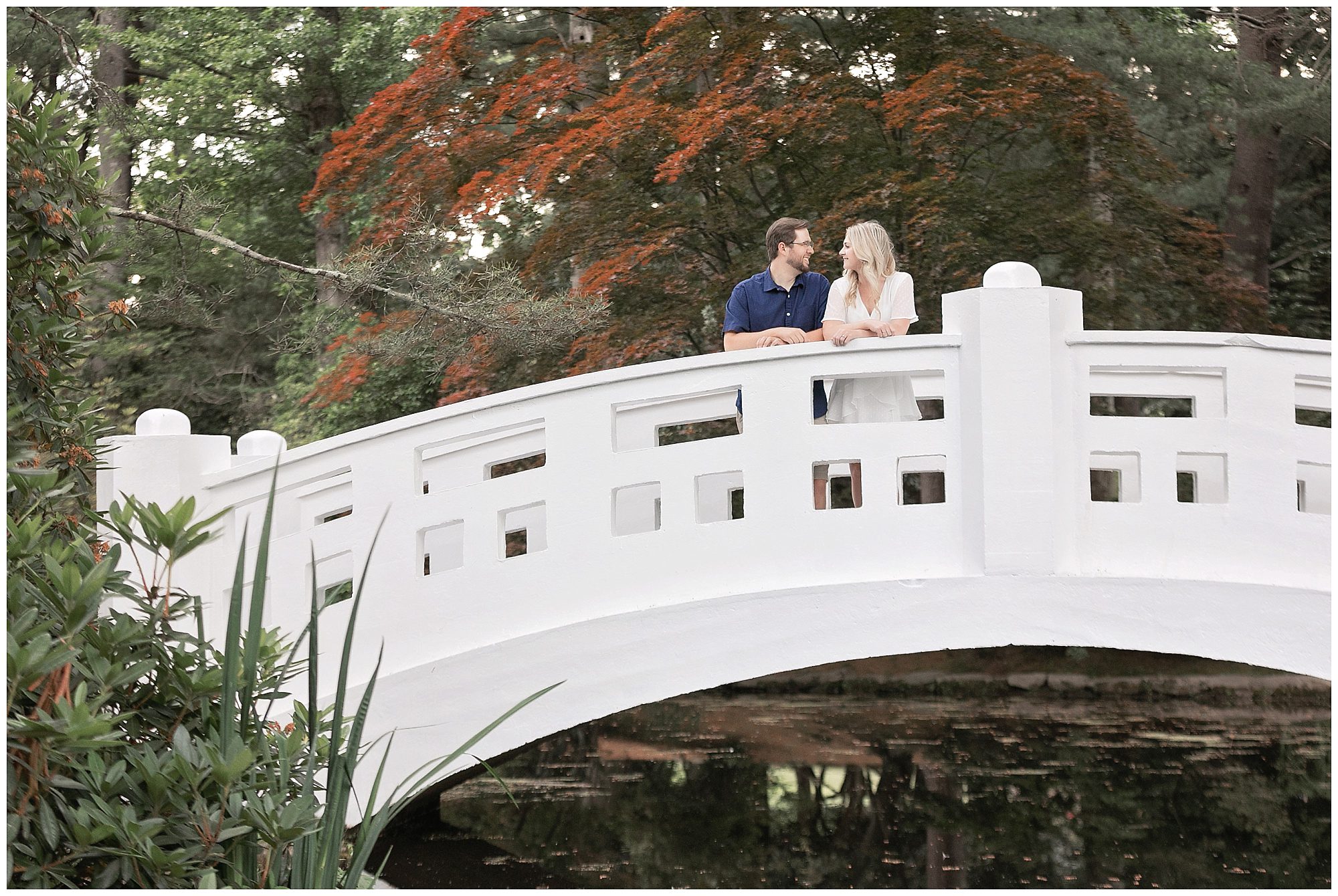 engaged couple on a bridge