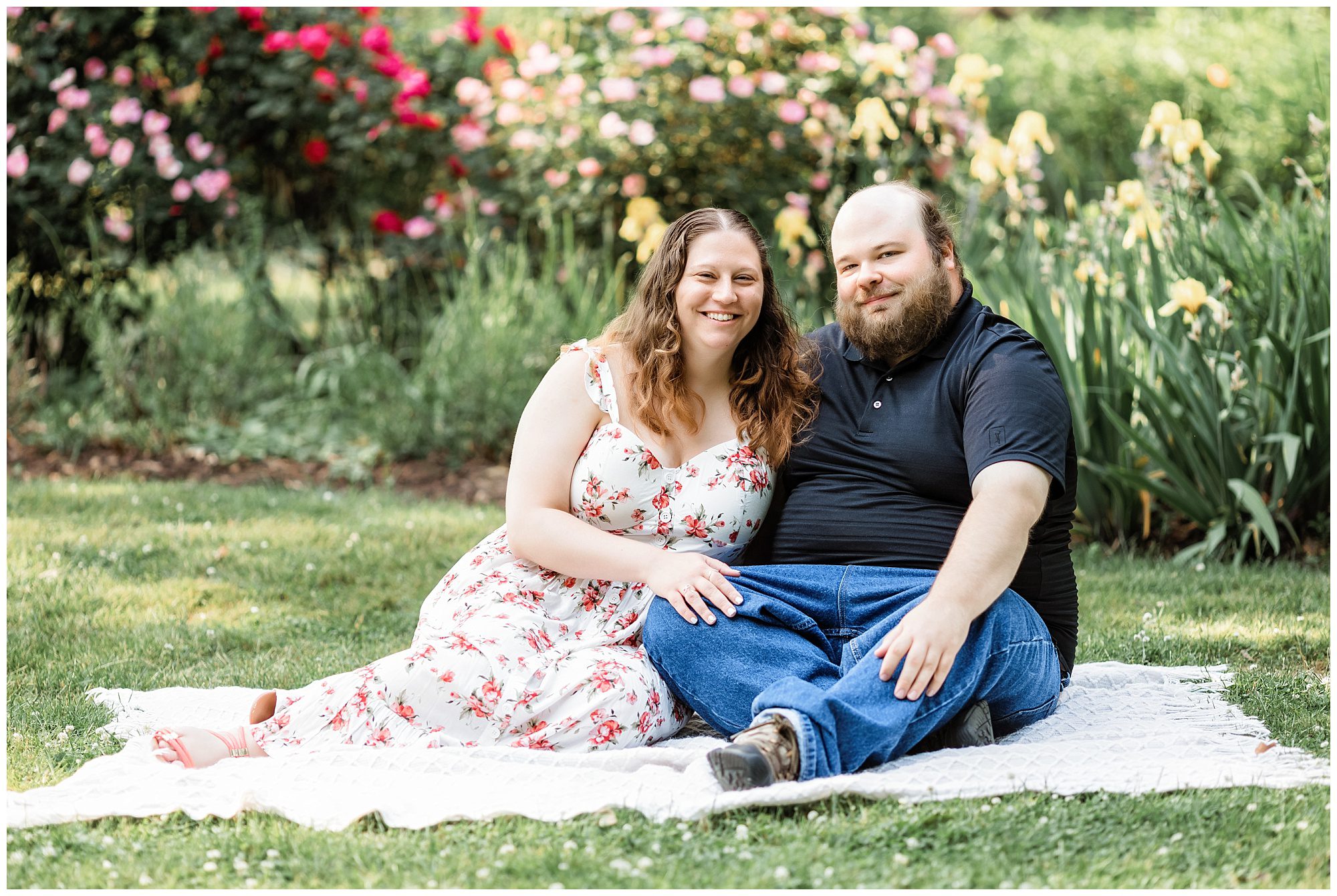engaged couple sitting on blanket