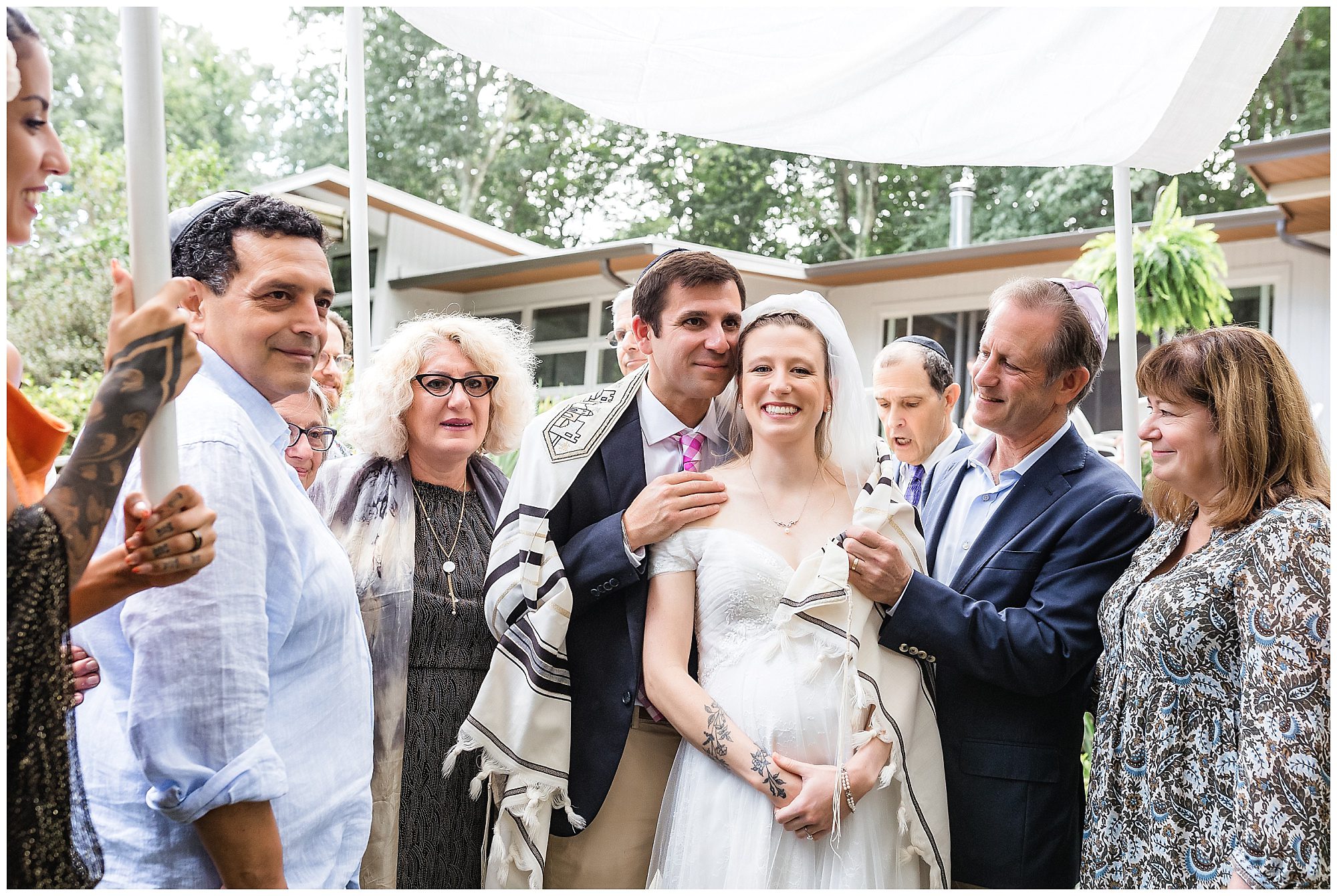 bride and groom surrounded by their family