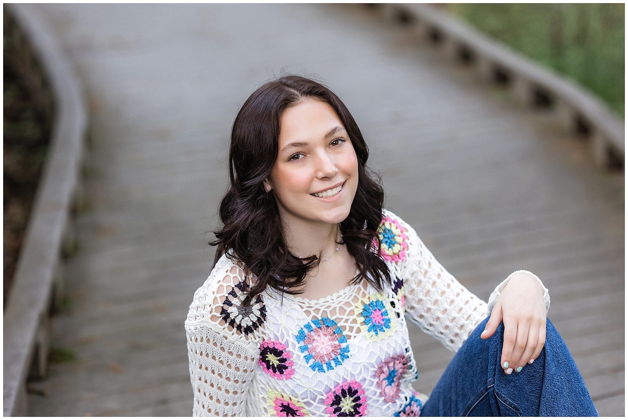 senior girl sitting on path