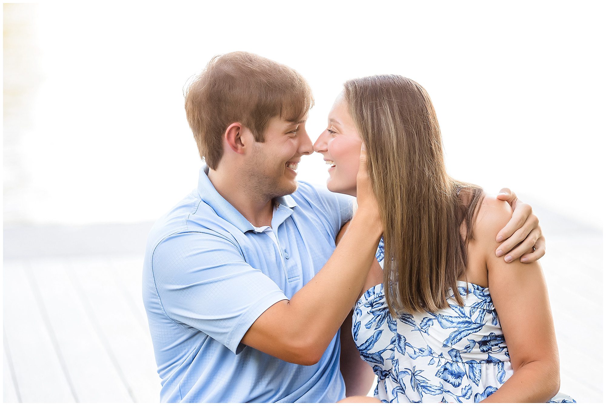 engaged couple by lake