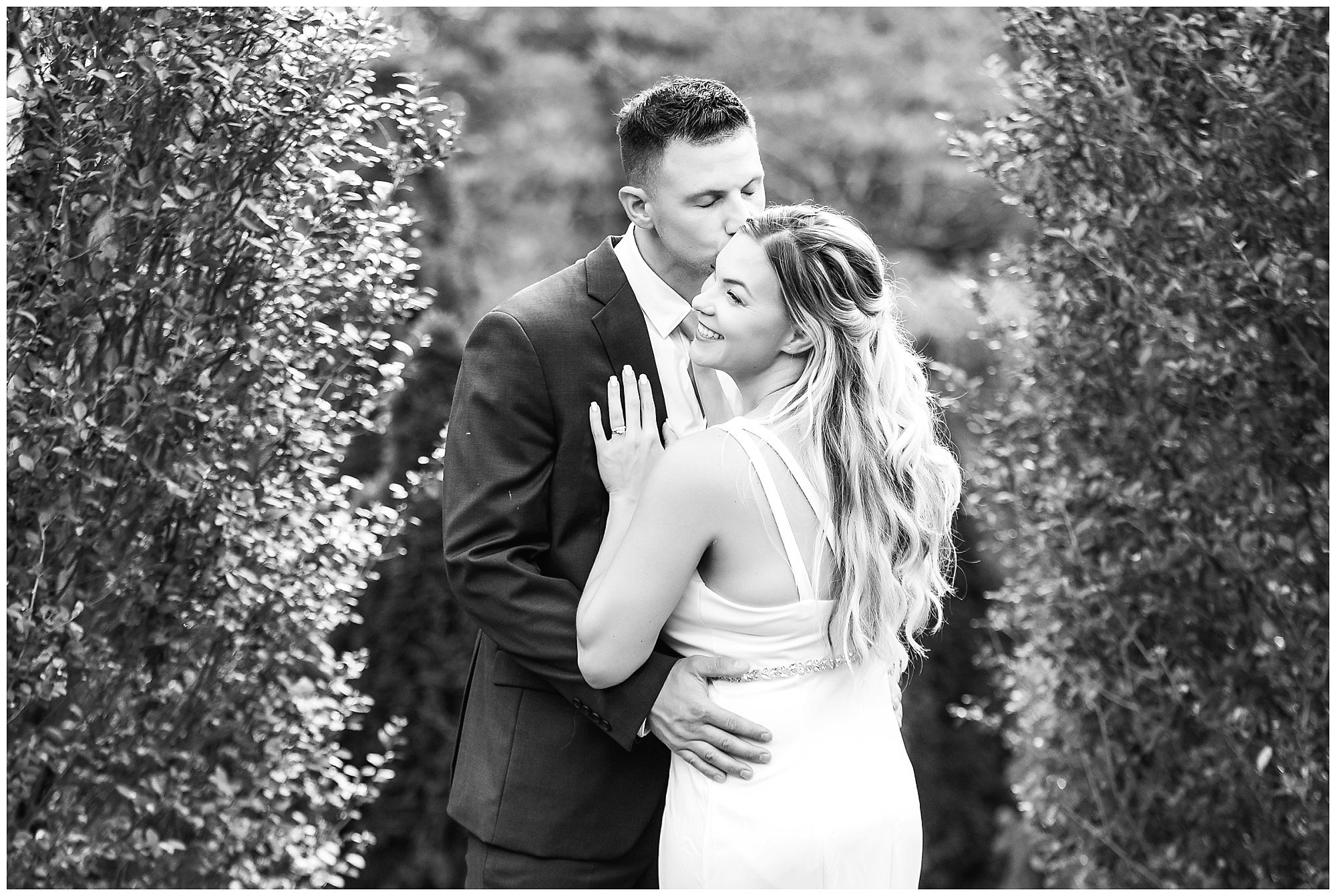 wedding portrait groom kissing bride