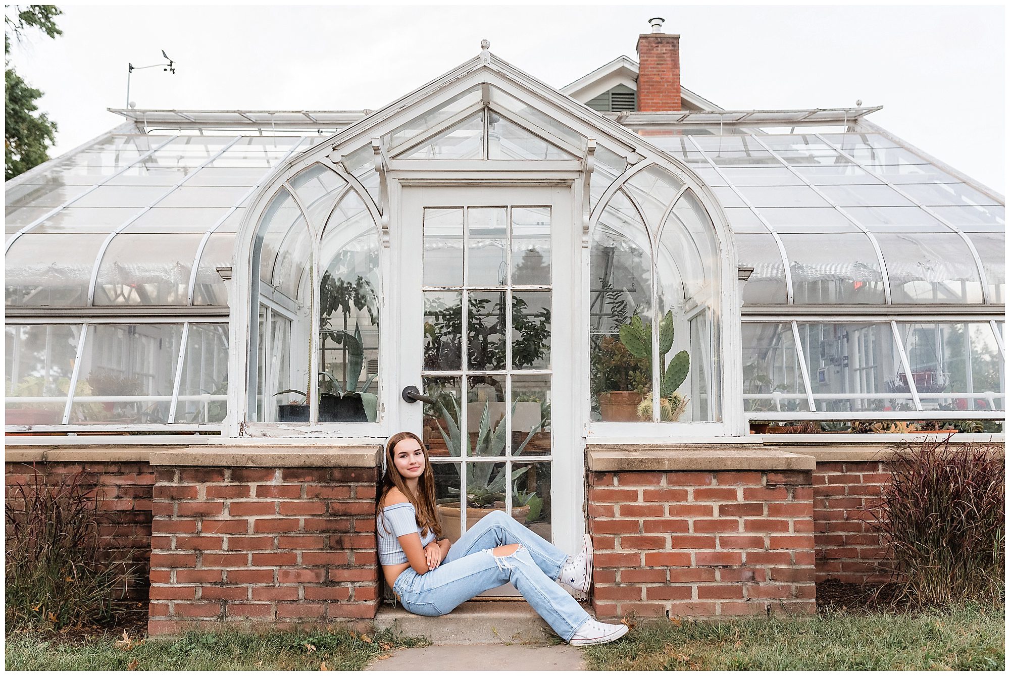 senior portrait by a greenhouse