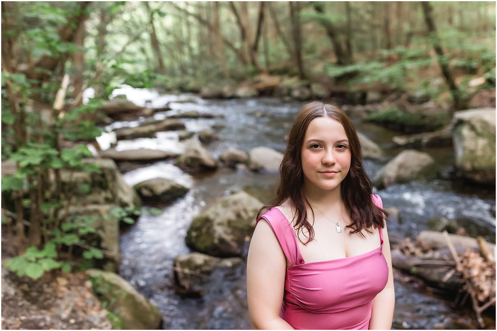 Senior portrait session at Enders Falls Senior standing in front of stream