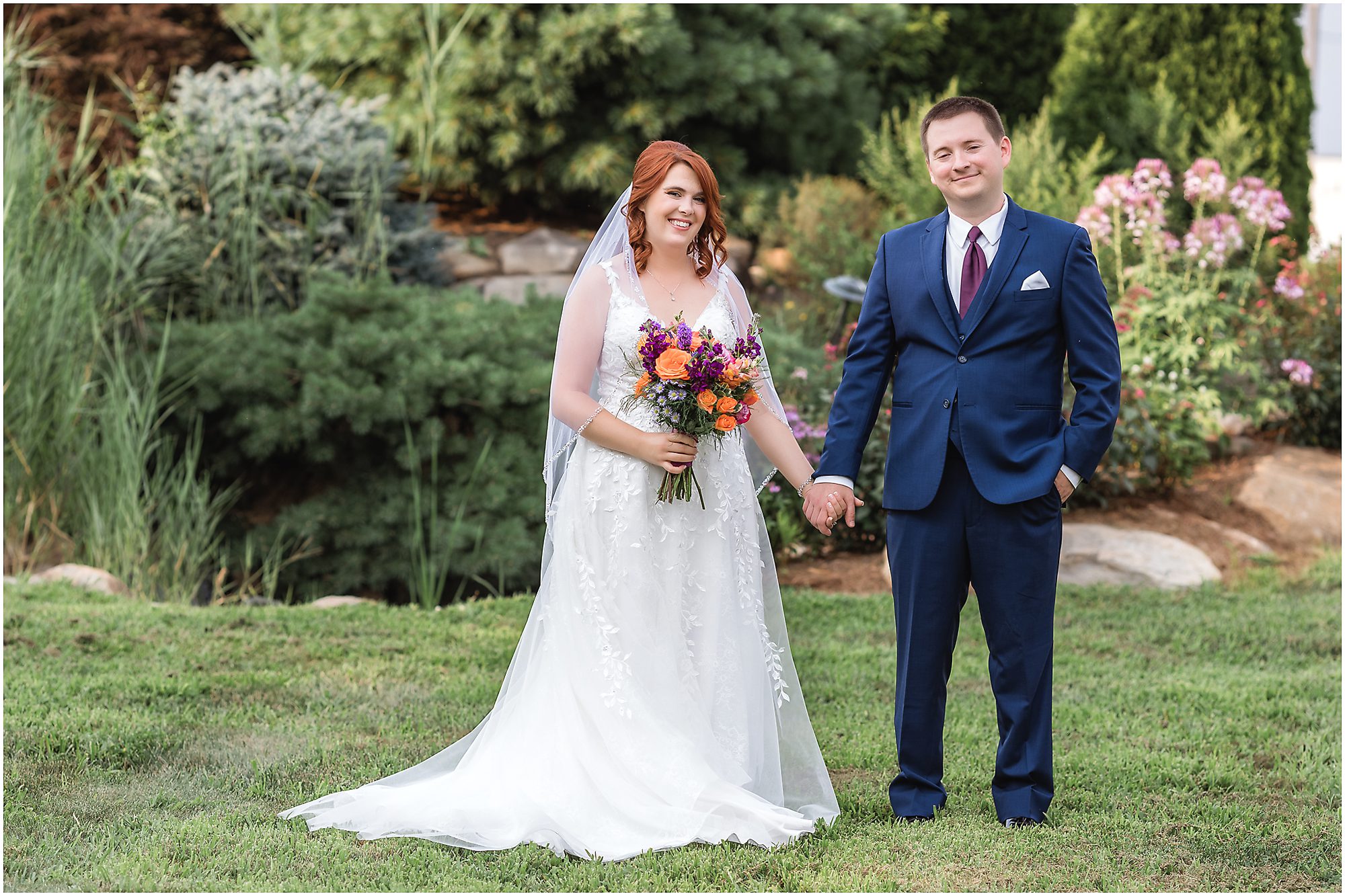 elopement couple in flower garden with pond